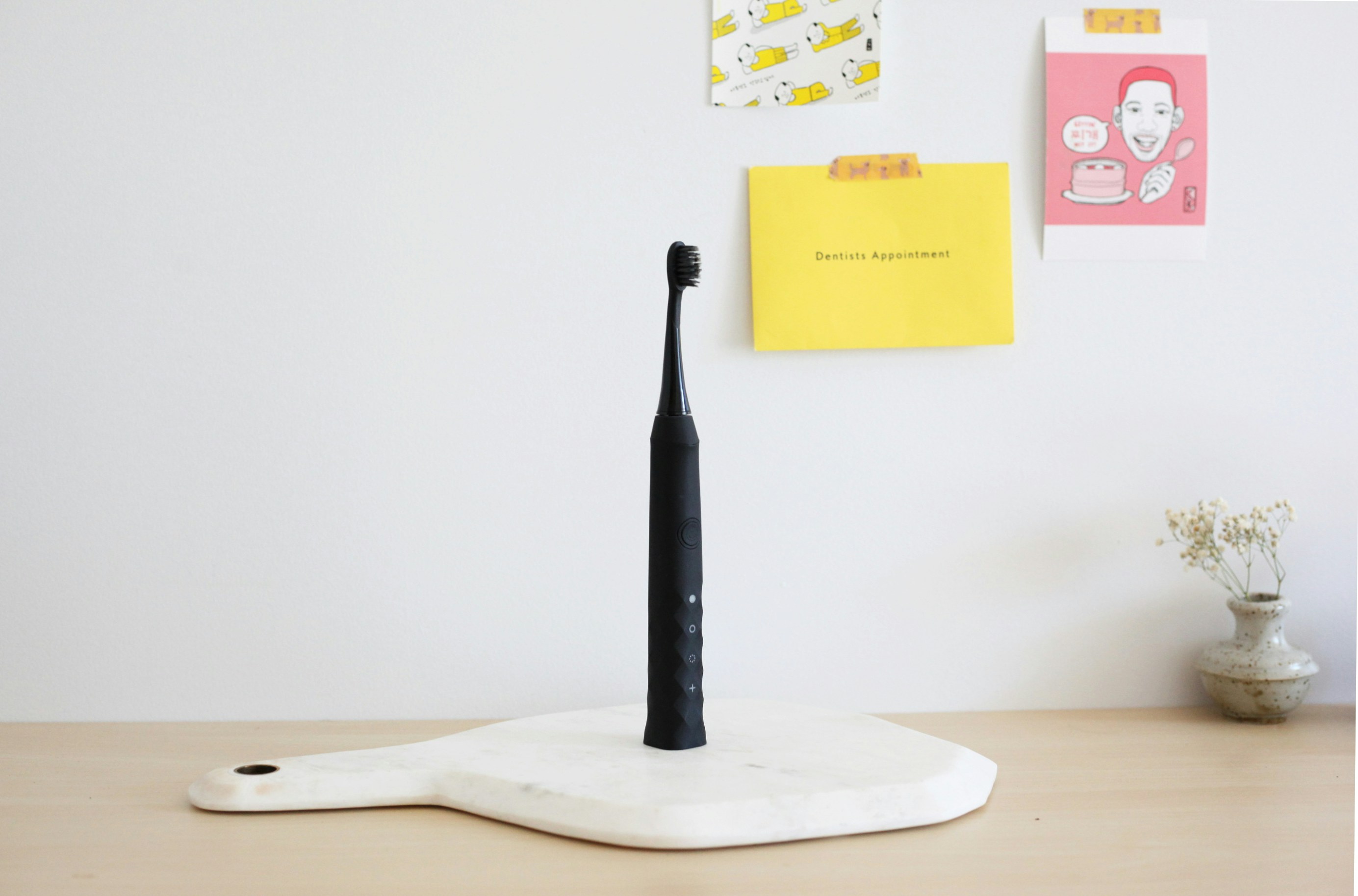 An electric toothbrush with a round head and soft filaments