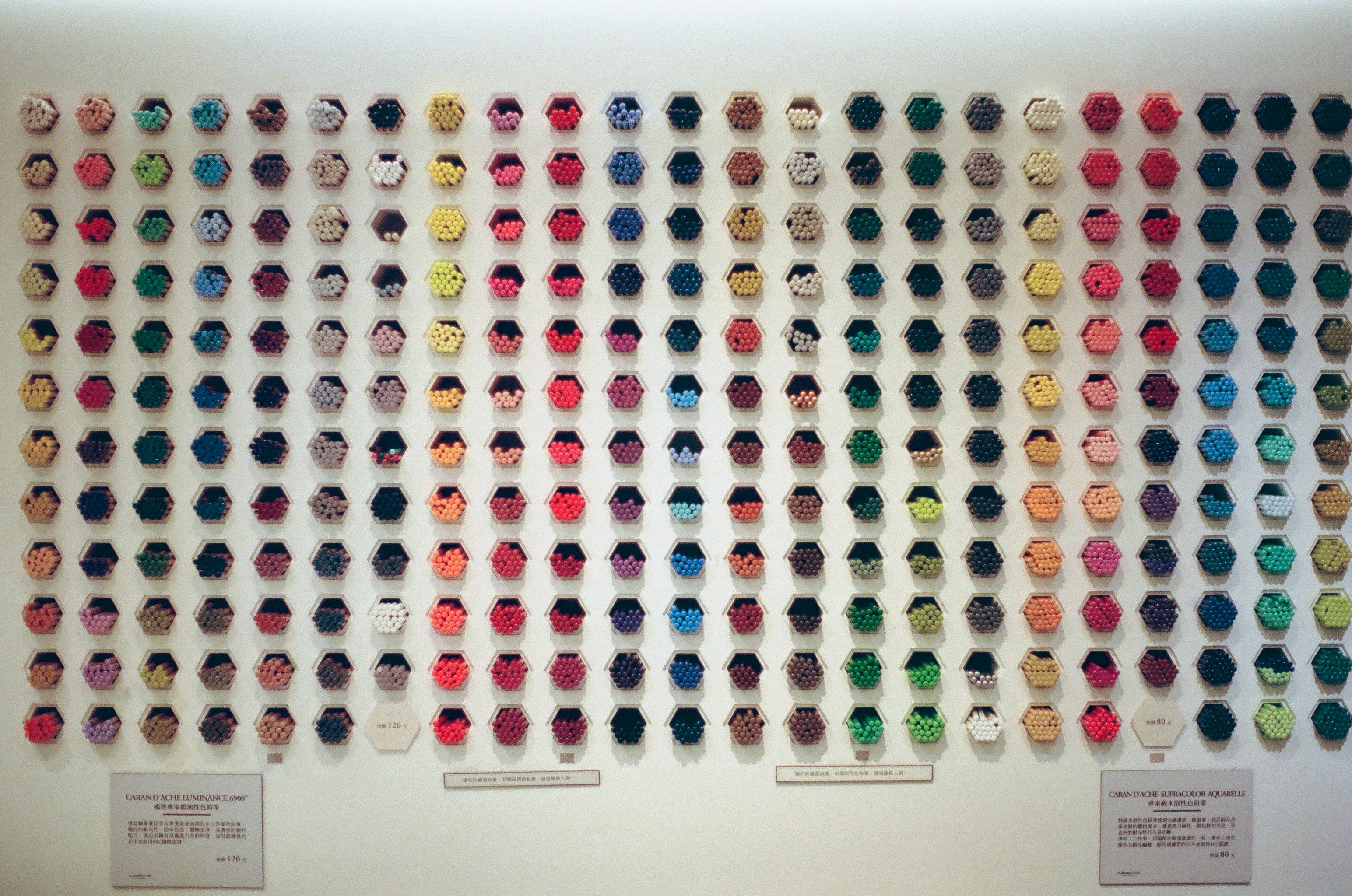 A display of various fabric swatches and color samples in a design studio