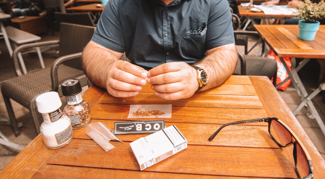 A jewelry designer sketching new sterling silver ring designs on a tablet.