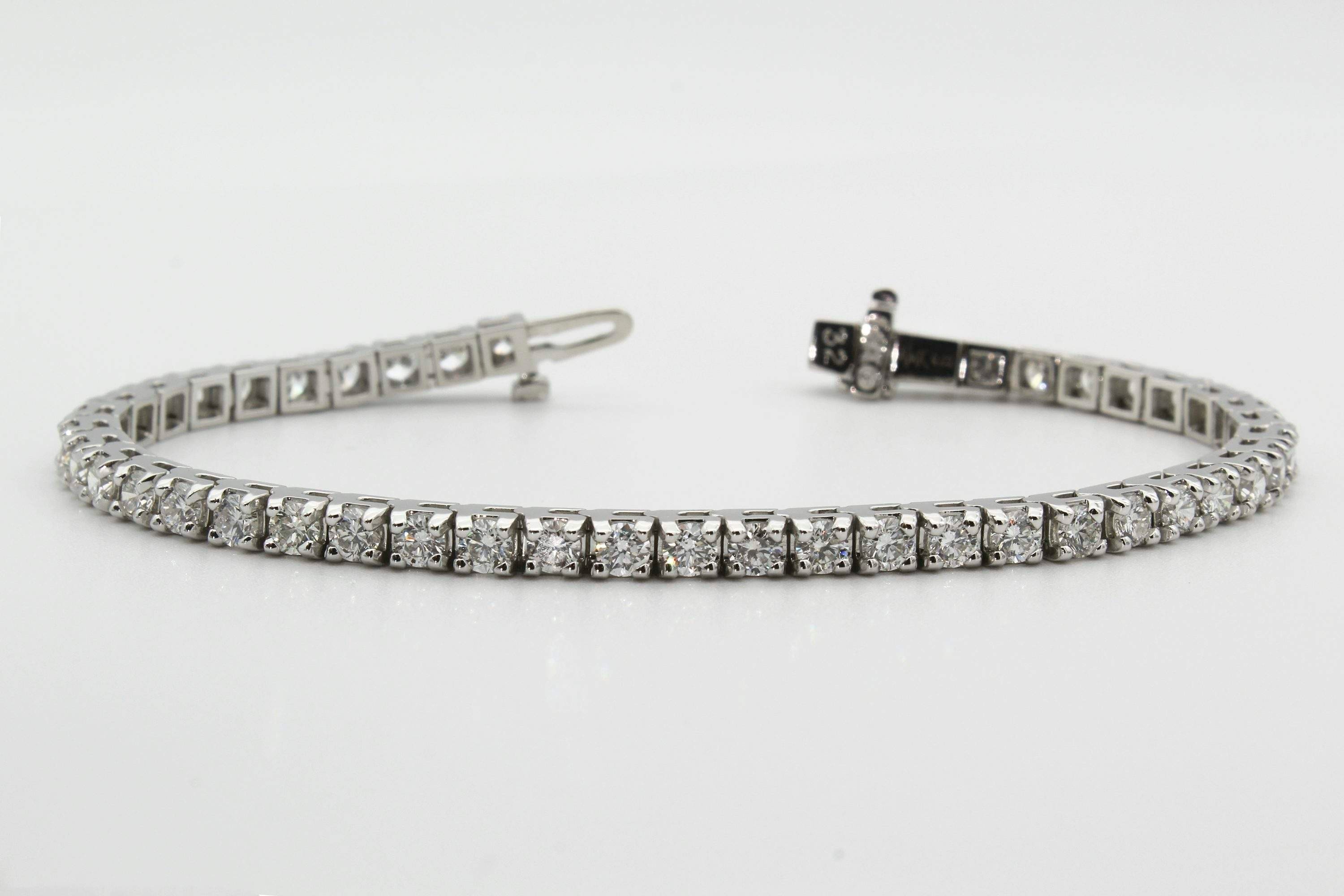 Silver tennis bracelet arranged in a horizontal product view