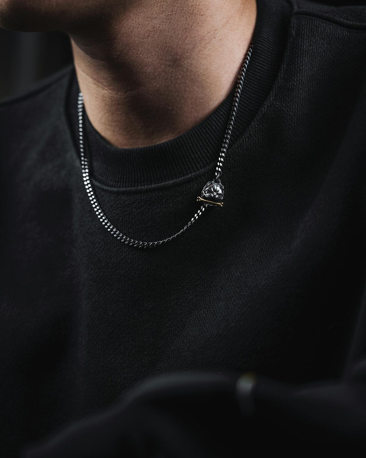 Hands wearing layered rings and bracelets as a styling reference