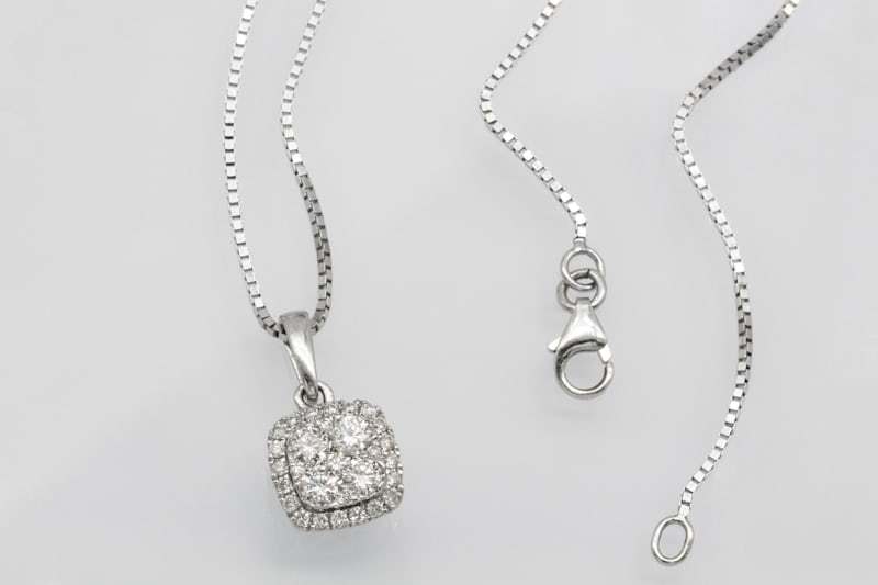 Silver pendant necklace displayed in a jewelry setting