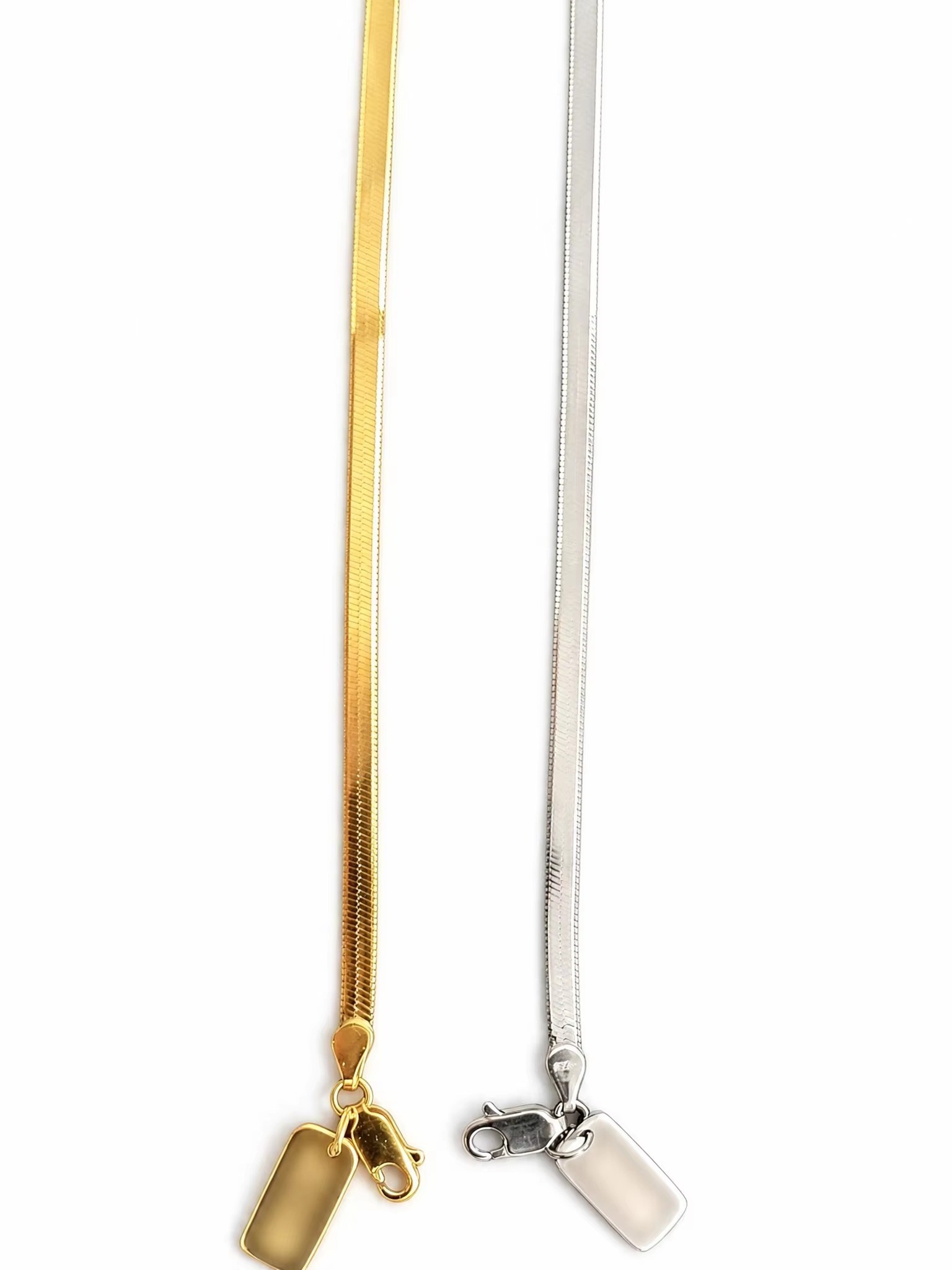 Colares de corrente de cobra em ouro e prata com etiquetas de marca.