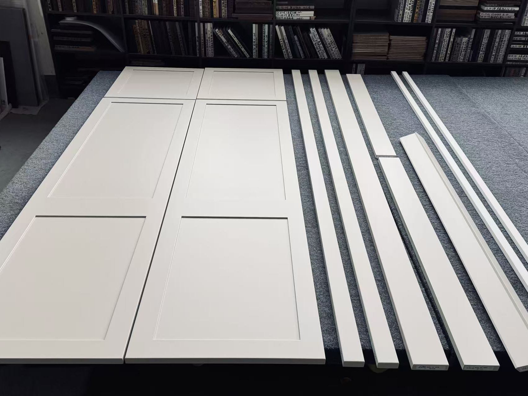 Custom shaker door panels and frame parts staged for inspection in the ZoneIdeal factory