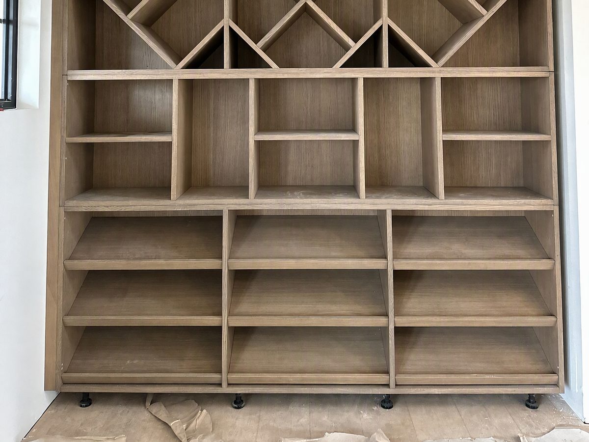 Full-height open shelving and compartments in wood veneer, sized to the room