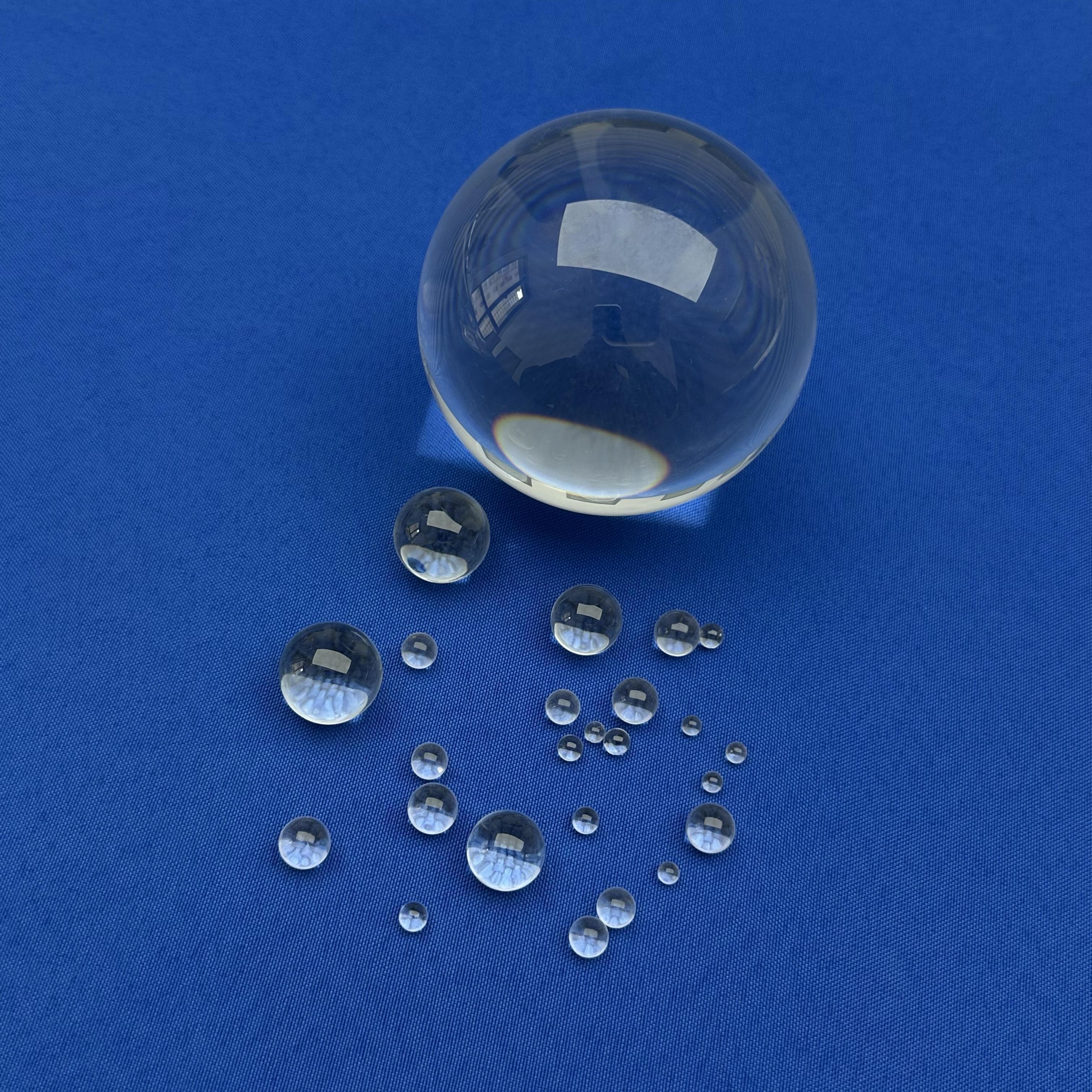Polished sapphire half ball lens core component for low-loss optical fiber coupling devices