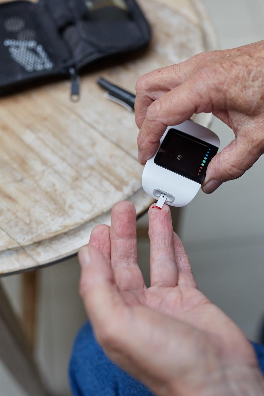 Patient performing capillary blood glucose measurement with a wearable medical sensor at home