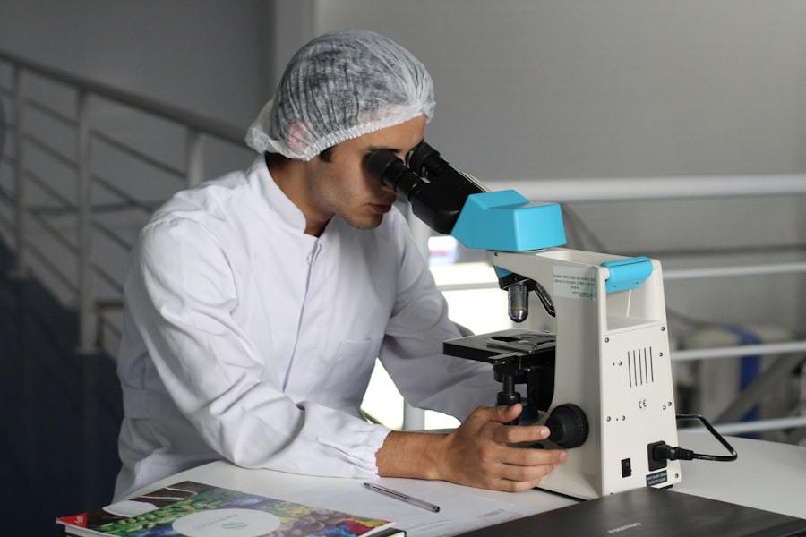 Quality engineer inspecting a polished optical flat under a measuring microscope for medical sensor surface inspection