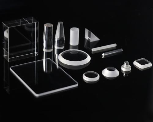 Glass component held near a flame to illustrate optical inspection under thermal exposure