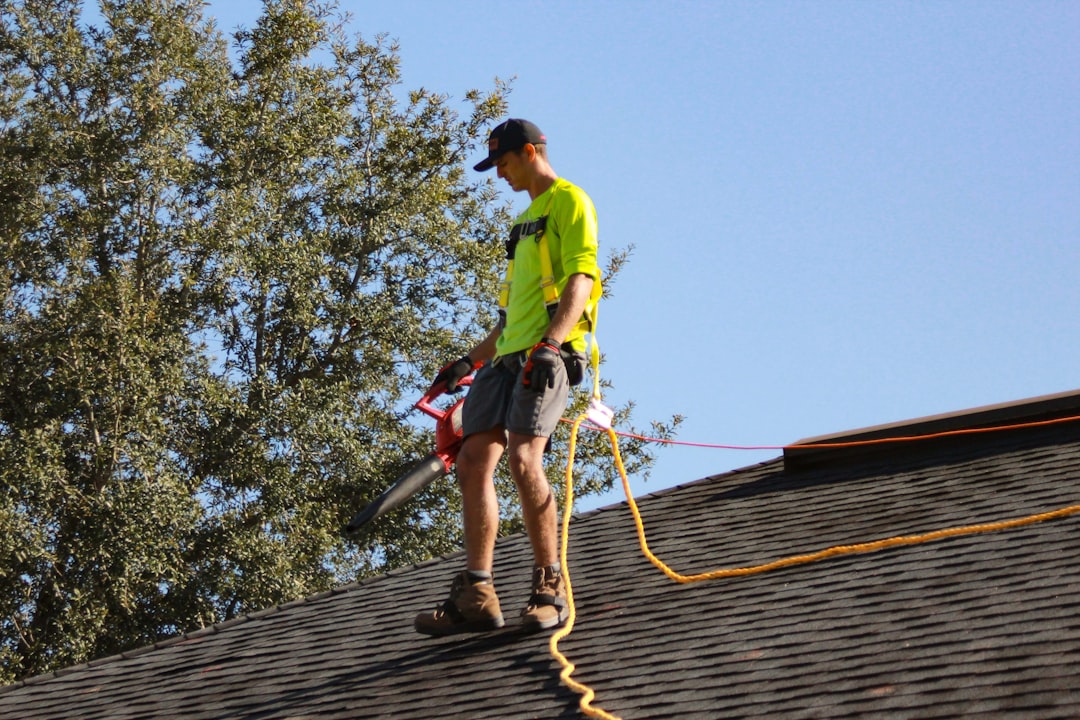 A professional safely cleaning rooftop solar panels