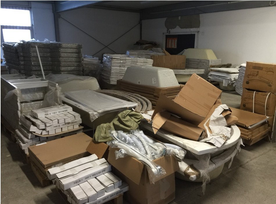 Half-assembled bathtub shells and stocked XMA and XMJA model boxes at GPP Bremen warehouse