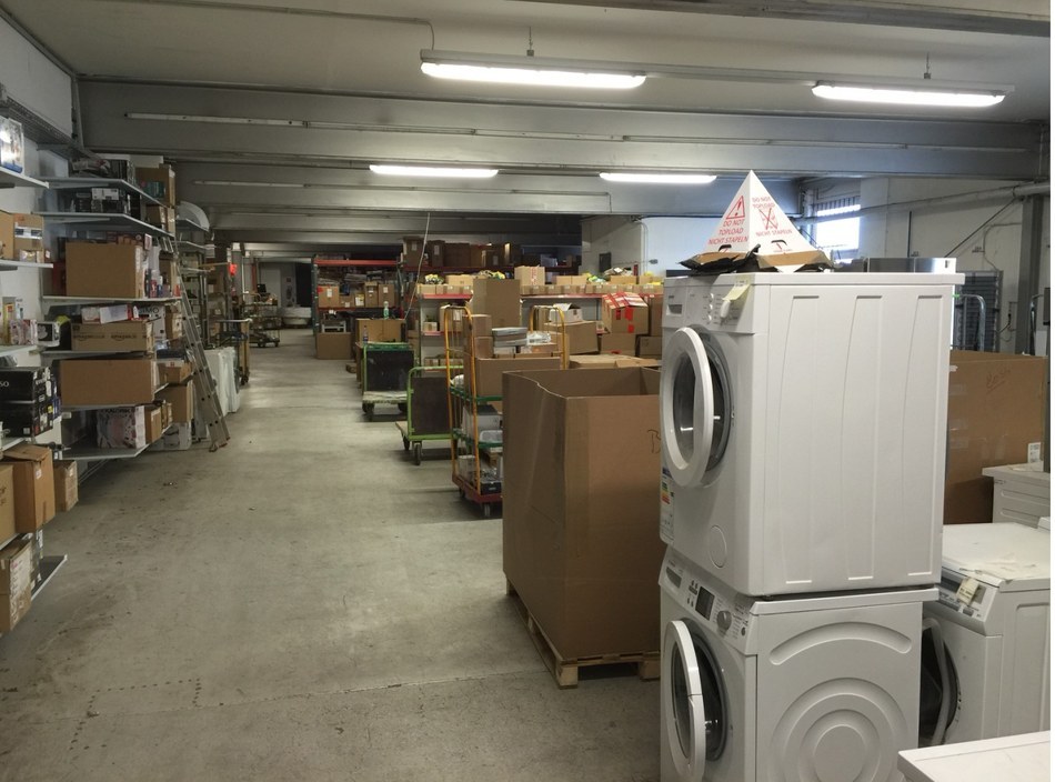 GPP warehouse main aisle in Bremen with amazon.de labeled stock