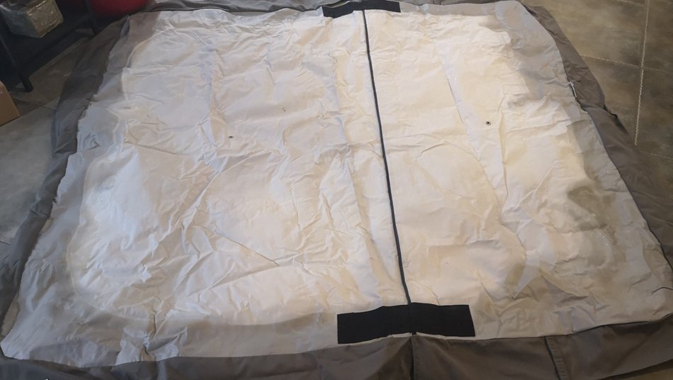 SEFM spa cover sample interior lining laid flat showing aged waterproof fabric and center zipper