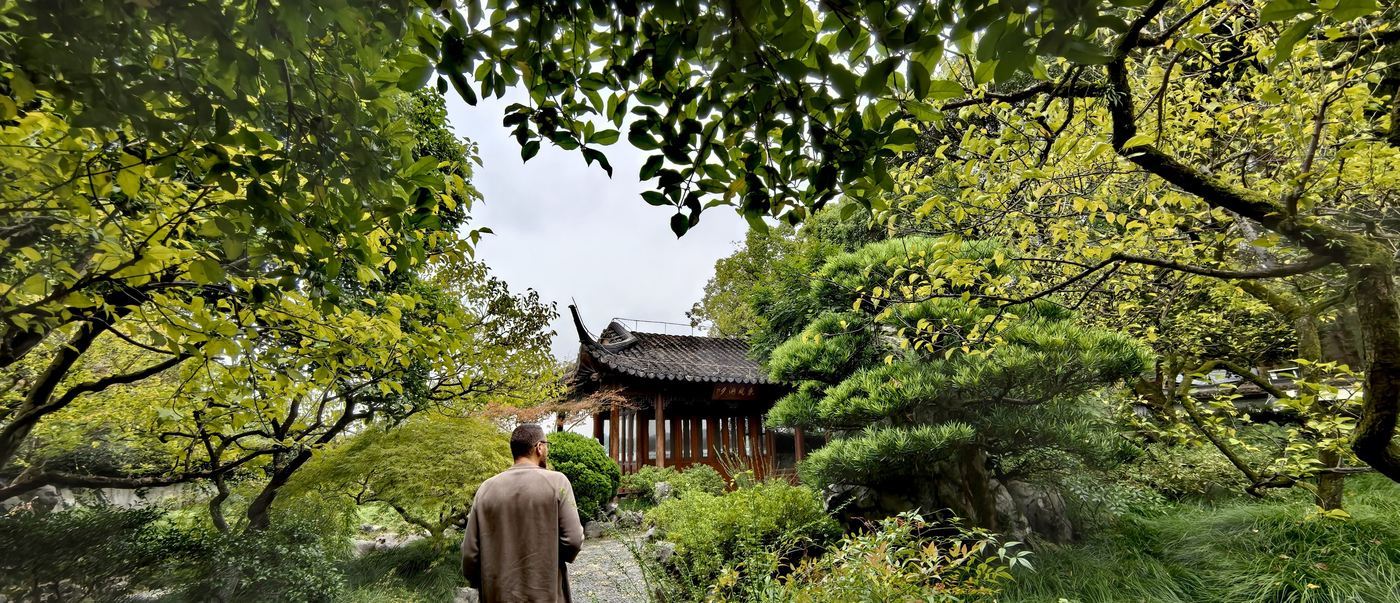 SSR customer touring a traditional Chinese garden and pavilion in Hangzhou