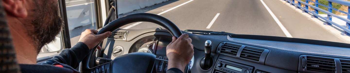 Driver at the wheel with a dashcam view of the road ahead