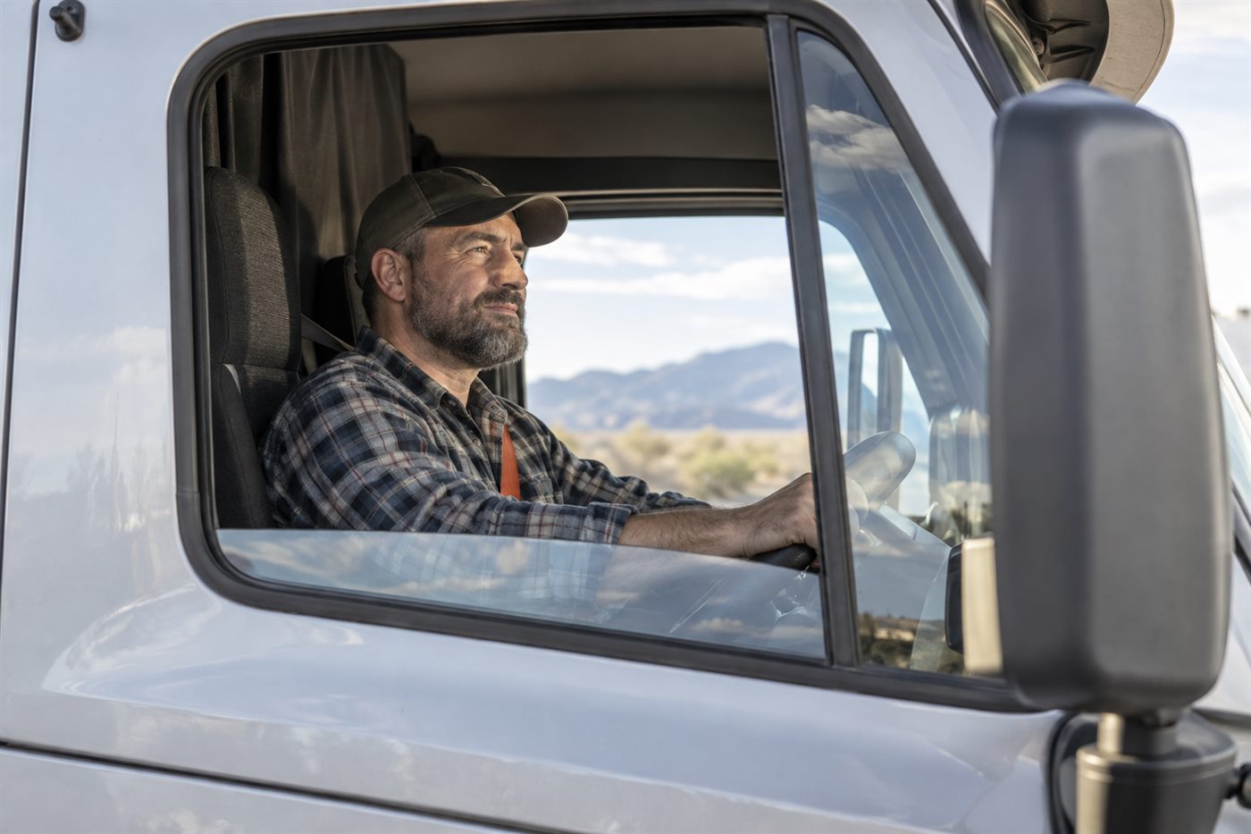 A professional driver seated in a commercial truck cab
