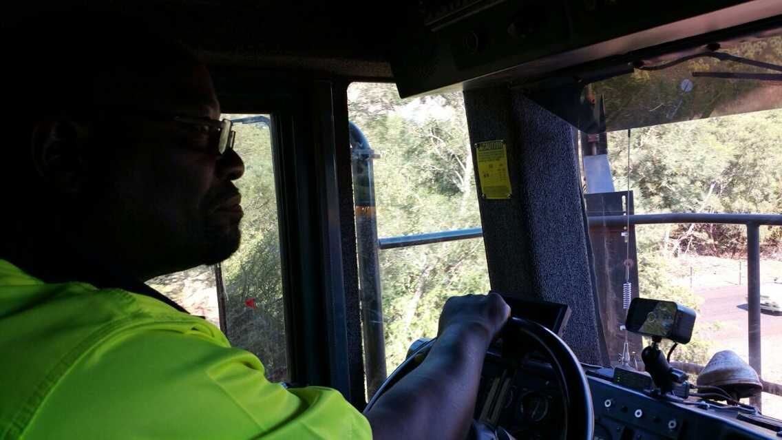 Heavy 200-ton open-pit mining dump truck operating on quarry haul ramp.