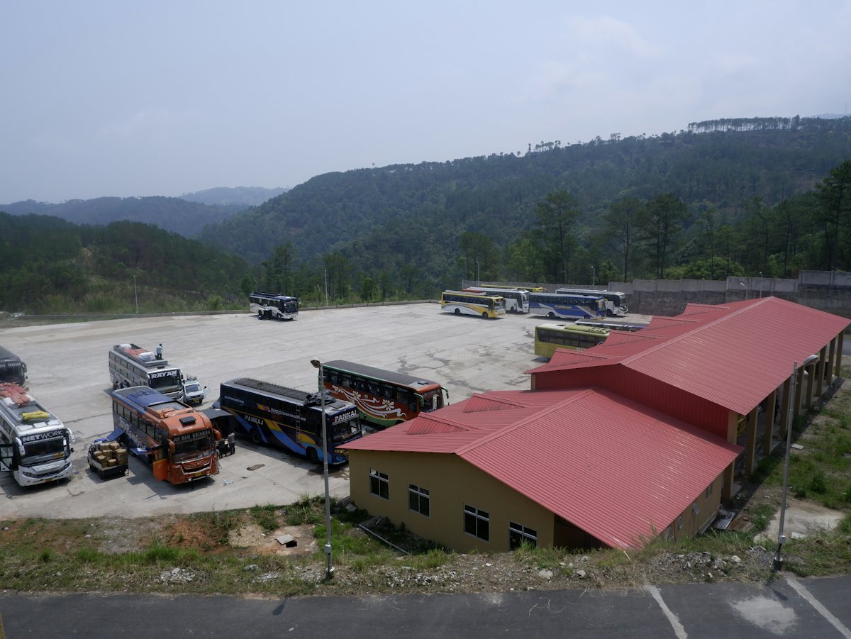 Commercial buses parked together in a vehicle depot