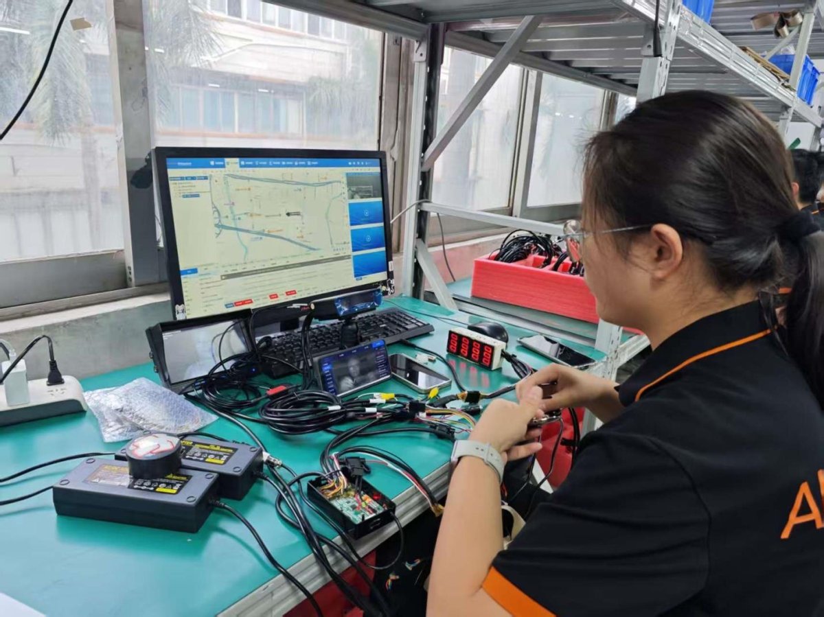 Engineer testing a device at a function test station
