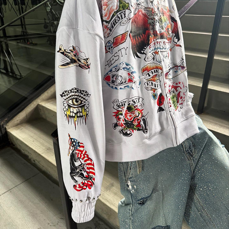 Model wearing white rhinestone zip up hoodie with vintage artwork, manufactured by leading hoodie manufacturers in China for upscale fashion brands