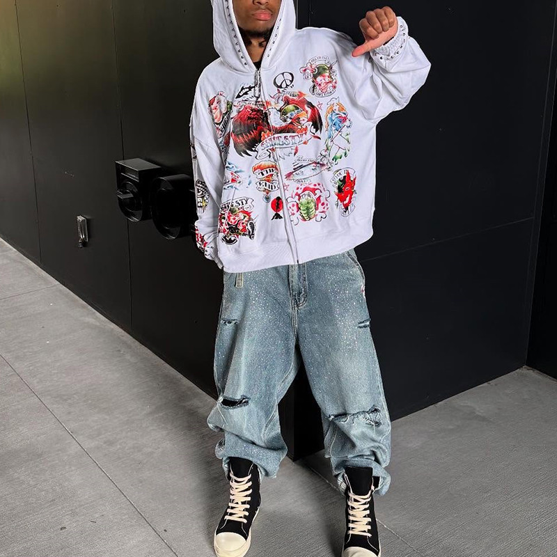 Close-up of custom streetwear hoodie sleeve, with all-over DTG vintage artwork and rhinestone details for a global market