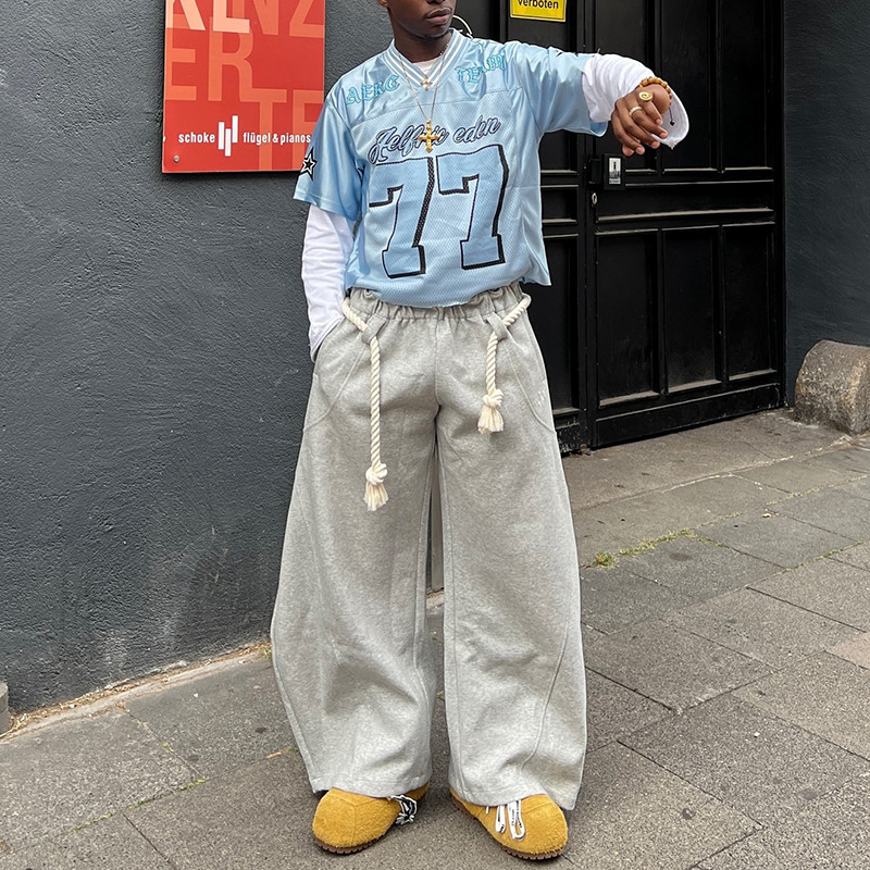 Cropped streetwear jersey in blue with bold varsity lettering, produced by Groovecolor