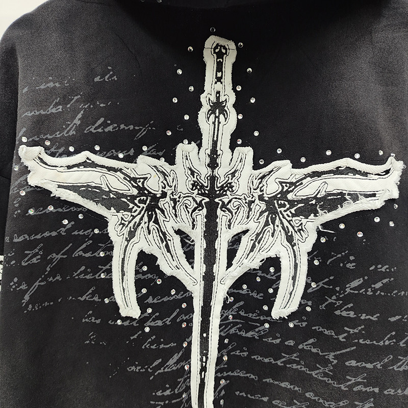 Close-up of embroidered patchwork with raw edge and rhinestones on Groovecolor's custom zip hoodie