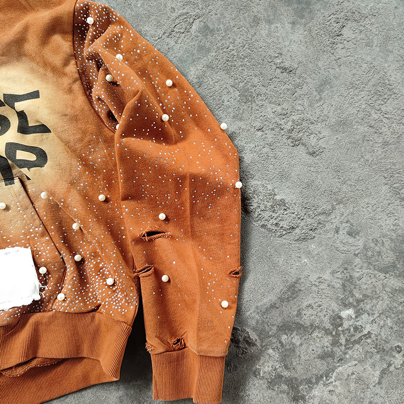Pearl and distress detail on sleeves of rust y2k hoodie, crafted by Groovecolor streetwear cut and sew manufacturers in China