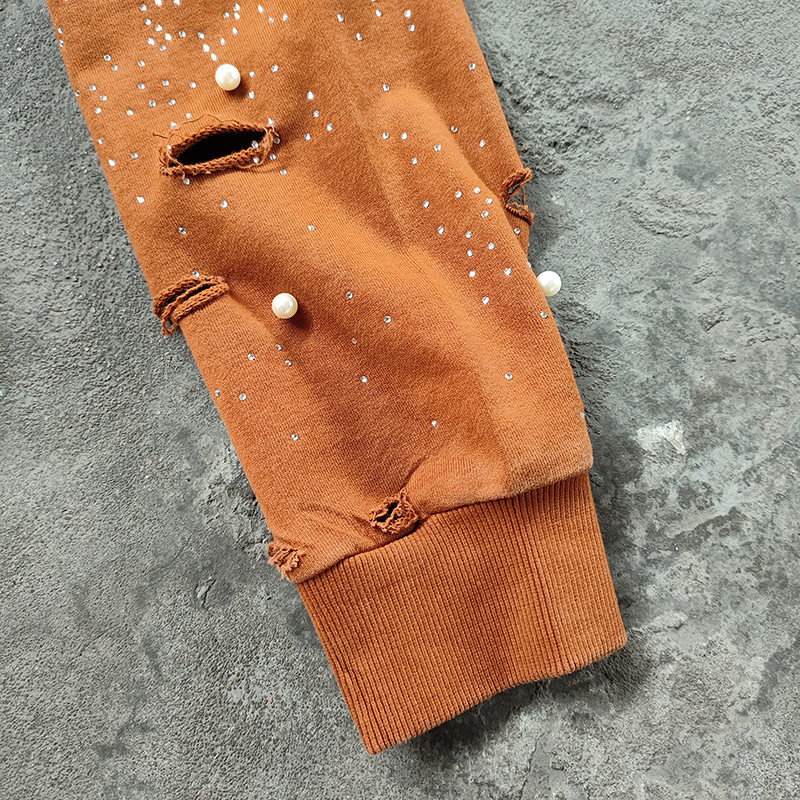 Sleeve detail showing ripped cuffs, pearls and rhinestones on Groovecolor y2k hoodie, custom acid wash hoodie factory China
