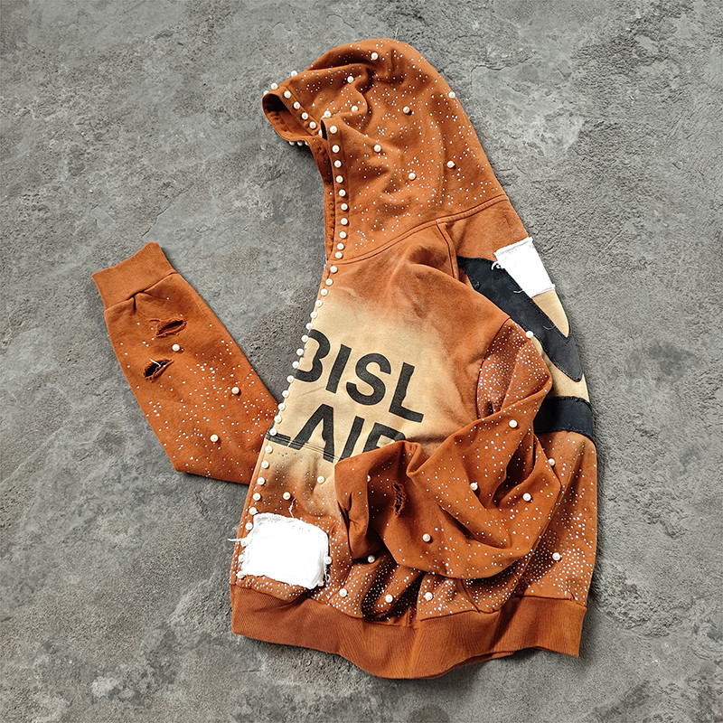 Model seated in rust y2k hoodie and camo pants, Groovecolor custom vintage streetwear hoodies for US and EU markets