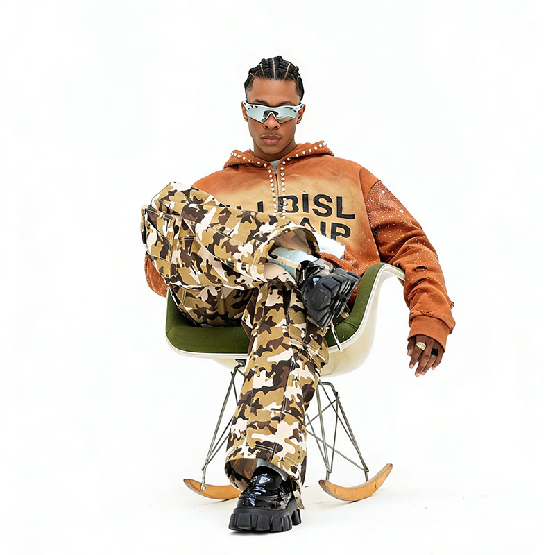 Close-up of a streetwear designer inspecting various high-GSM hoodie fabric swatches at a Groovecolor production facility in China.