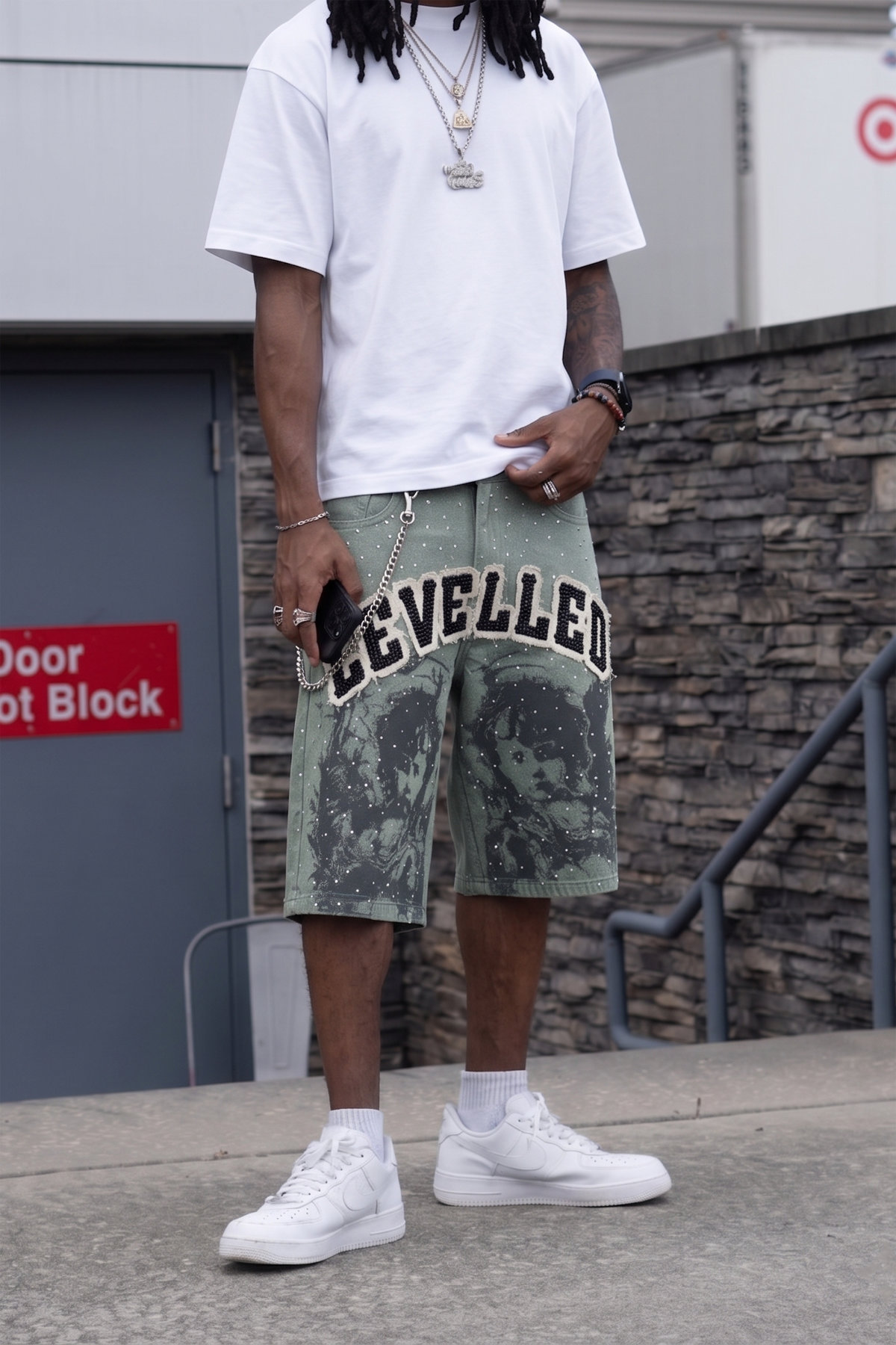 Black pattern screen printing at the bottom hem of denim shorts by Groovecolor