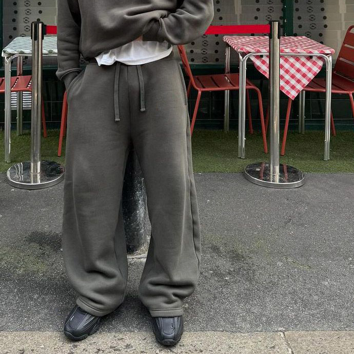 Quality control in streetwear manufacturing: Premium heavyweight custom baggy sweatpants inspection on a production line