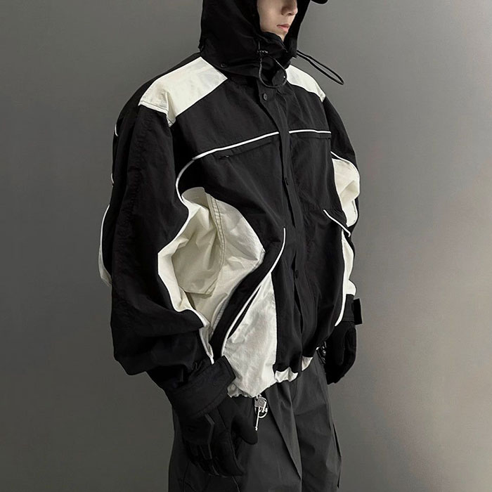 Quality control in streetwear manufacturing, custom tracksuit production line evaluating jacket and pant fit balance