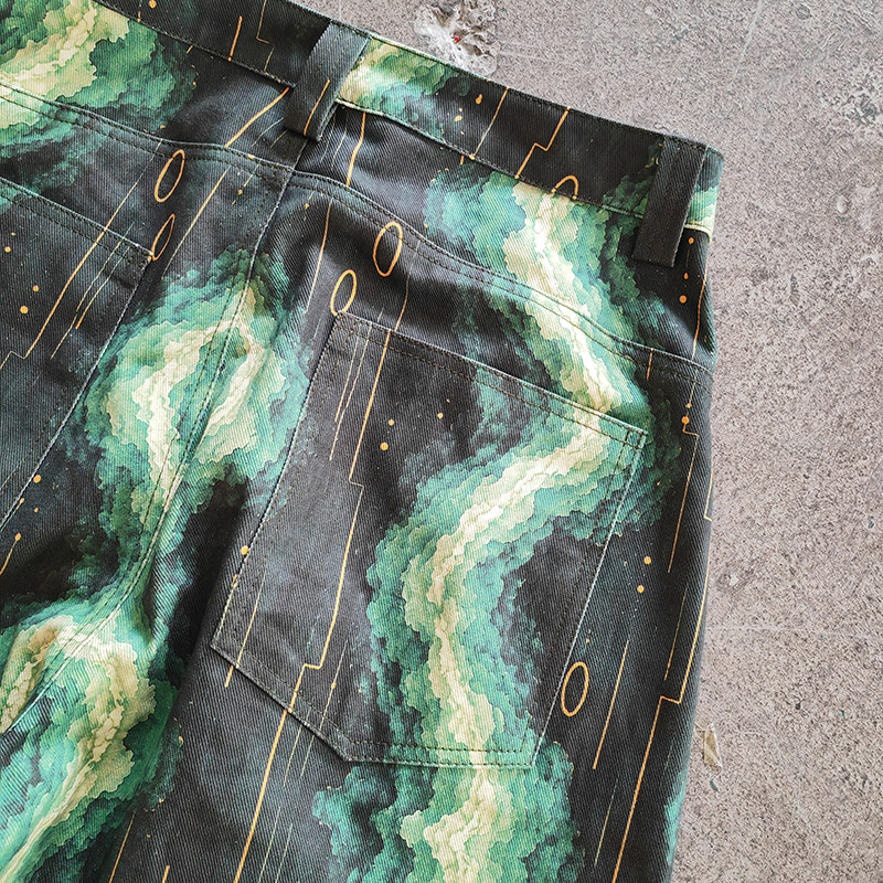 Streetwear collection styling reference for green wave all‑over‑print baggy denim jeans