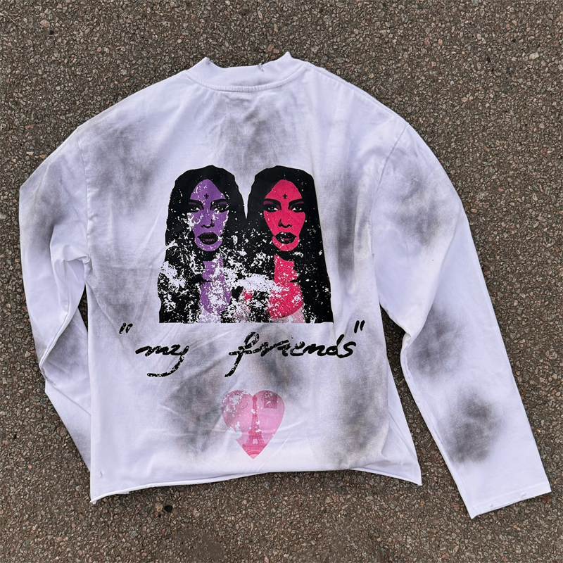 Oversized white long sleeve tee showcasing monkey wash and black spray paint effects by Groovecolor.