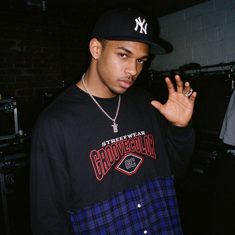 Raw‑edge patchwork seam close‑up of jersey‑flannel hybrid custom streetwear long‑sleeve top OEM