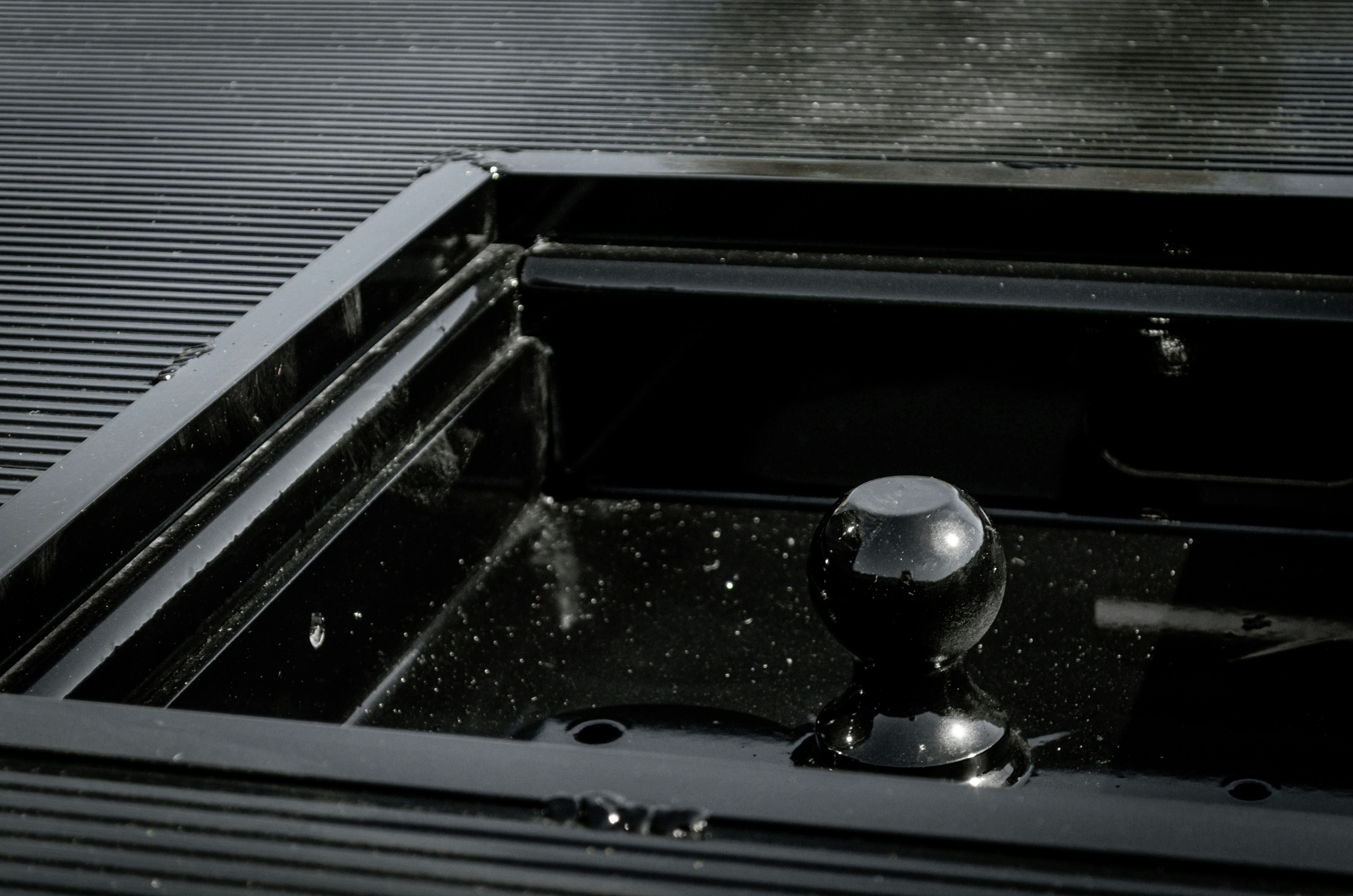 A floor-mounted stainless steel commercial mop sink with a high backsplash.