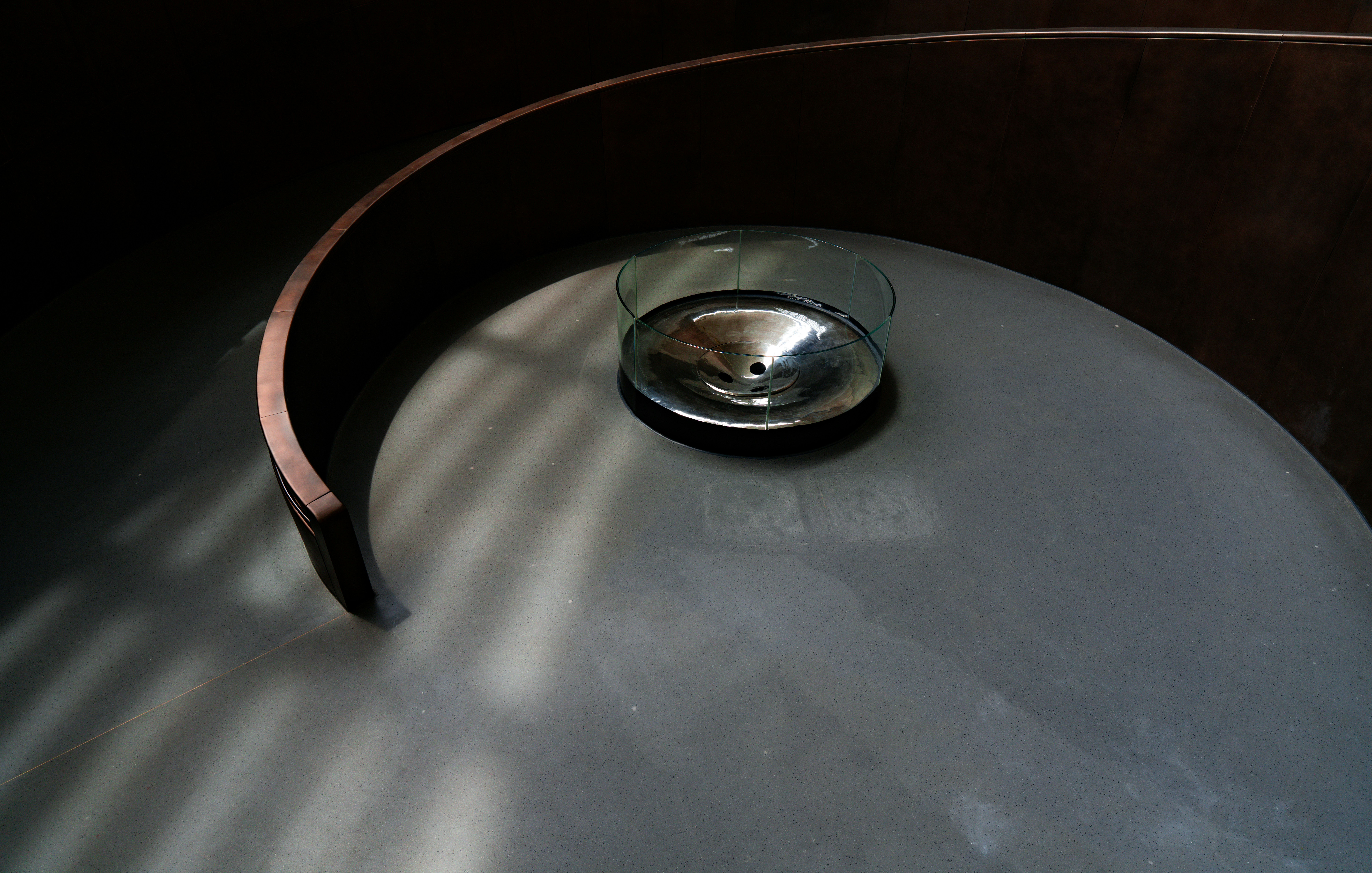 A split image showing the sleek, metallic finish of a stainless steel sink next to the matte, solid black of an epoxy resin laboratory sink.