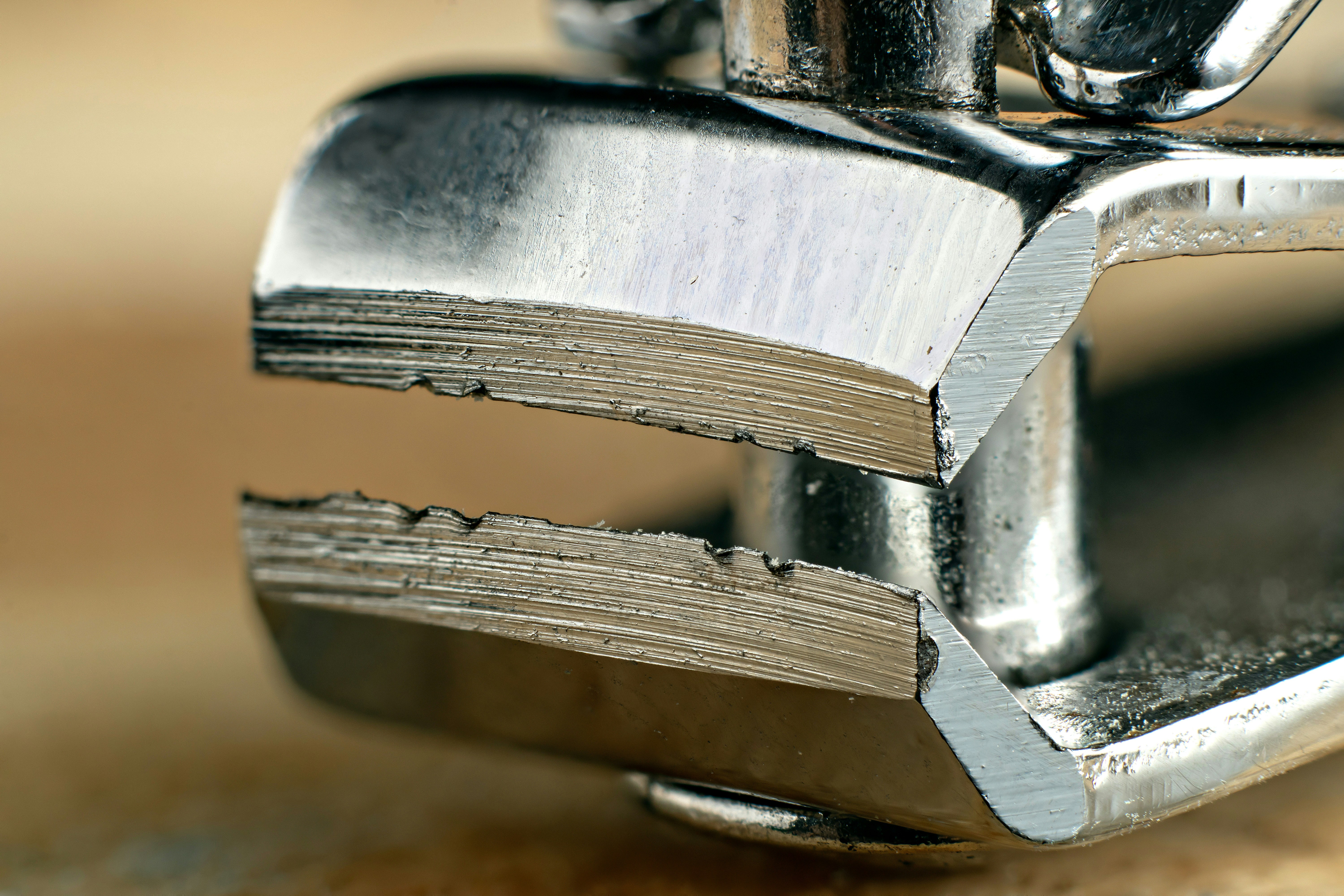 A close-up shot of a thick, 16-gauge stainless steel sink edge, showing its durability.