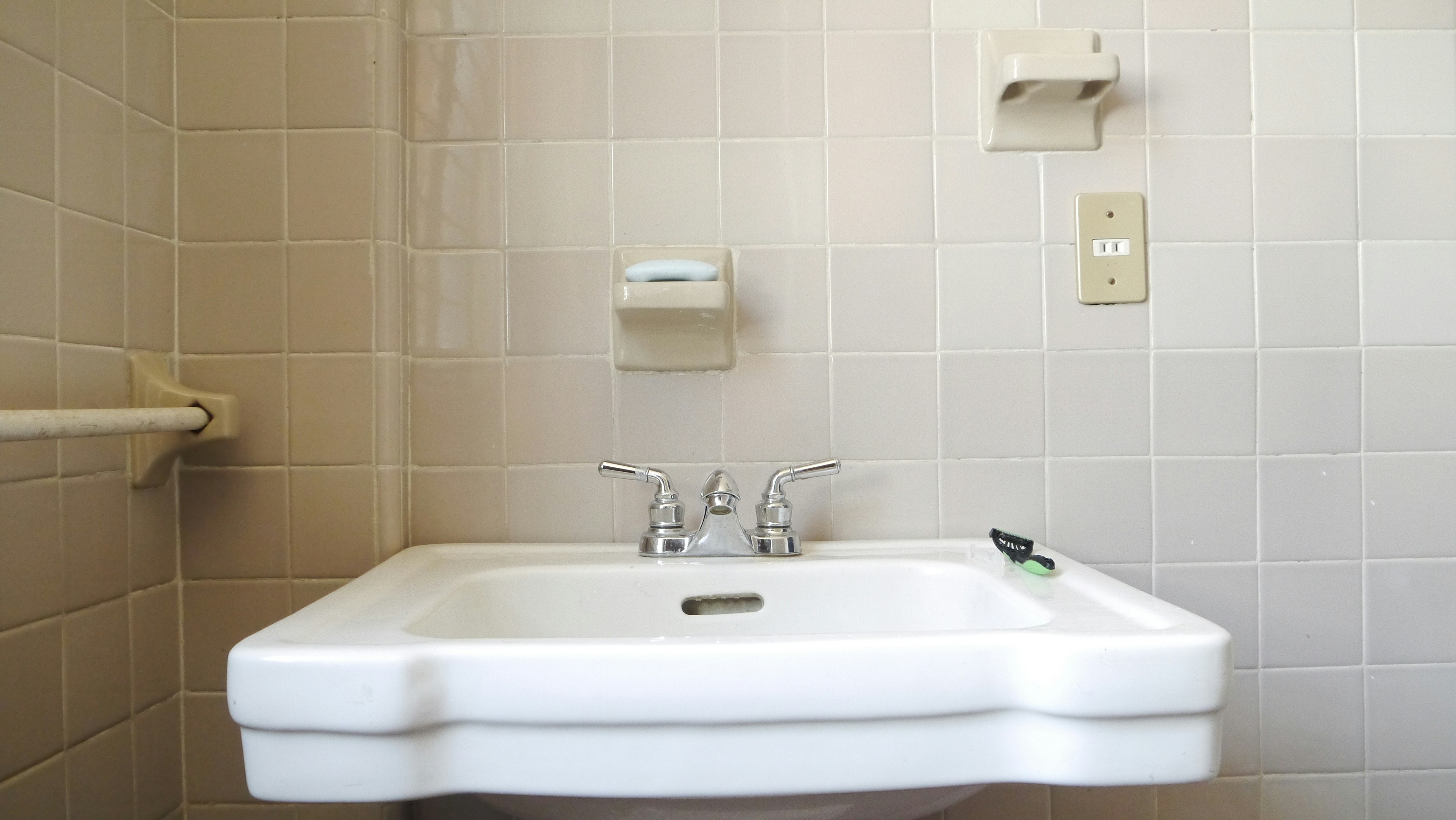 An image of an innovative hospital sink with a deep basin, offset faucet, and visible anti-splash features.