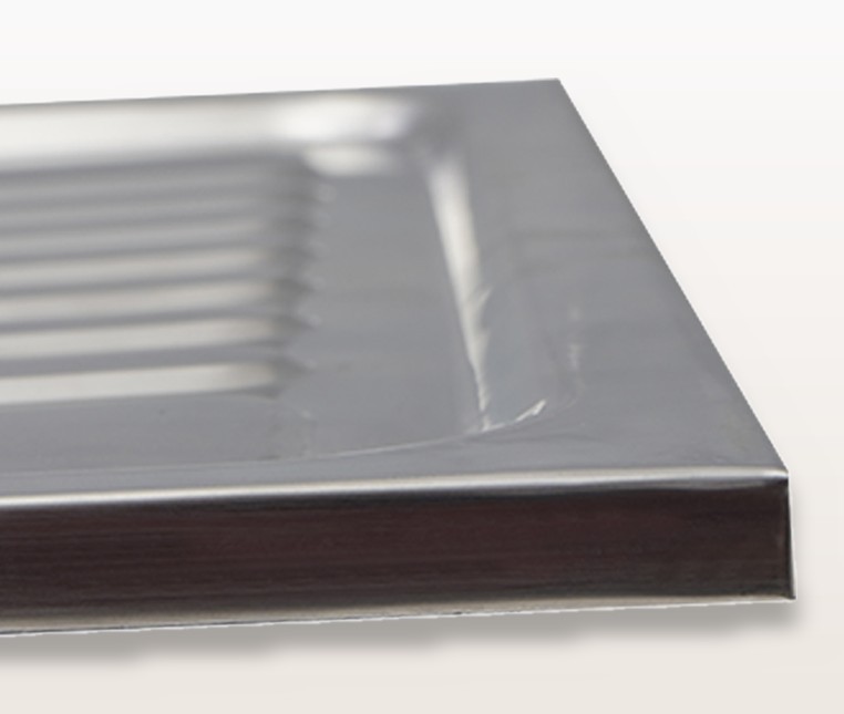 Wide flat rim and raised back splash lip on the rear edge of the stainless steel sink deck