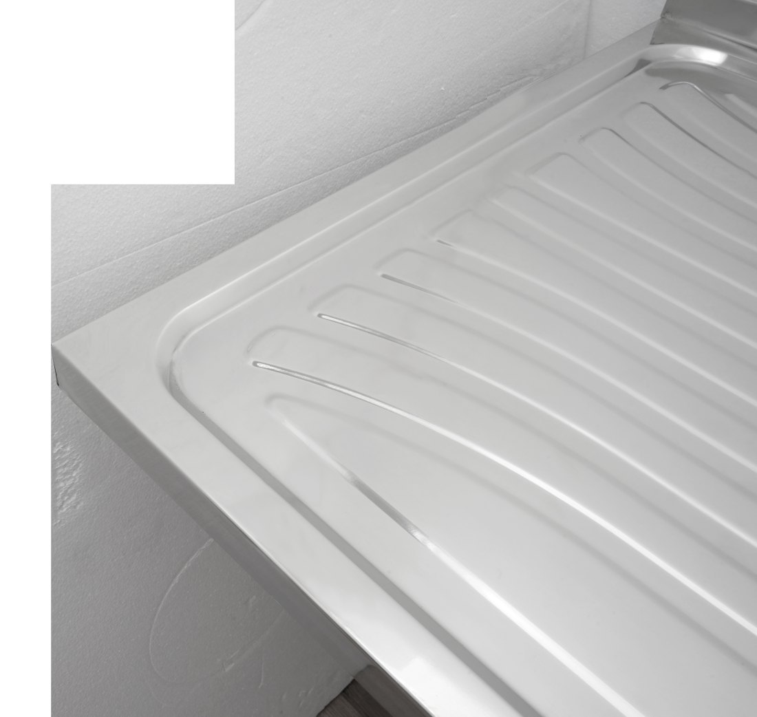 Underside and body detail of the drawn stainless steel sink showing the sloped base and sound deadening pad