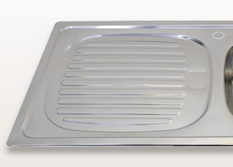 Close view of the integrated drainboard surface with overflow hole on the DD8643 sink