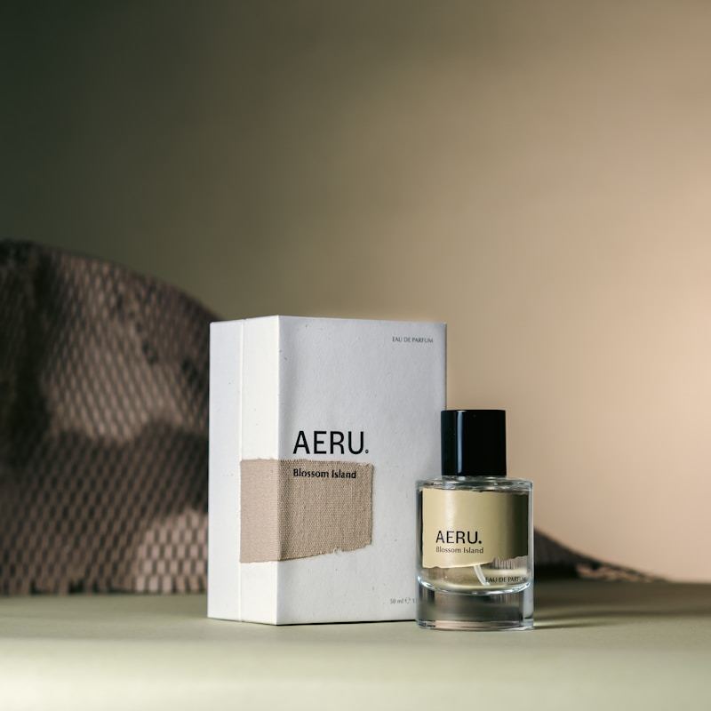 Perfume bottle displayed next to its custom packaging box