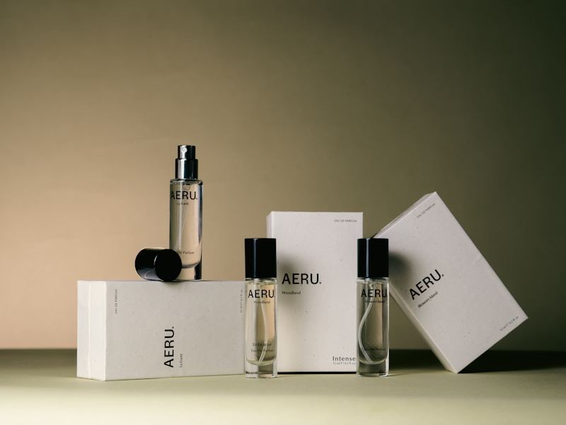 Luxury perfume bottles and custom packaging boxes displayed together on a minimalist surface