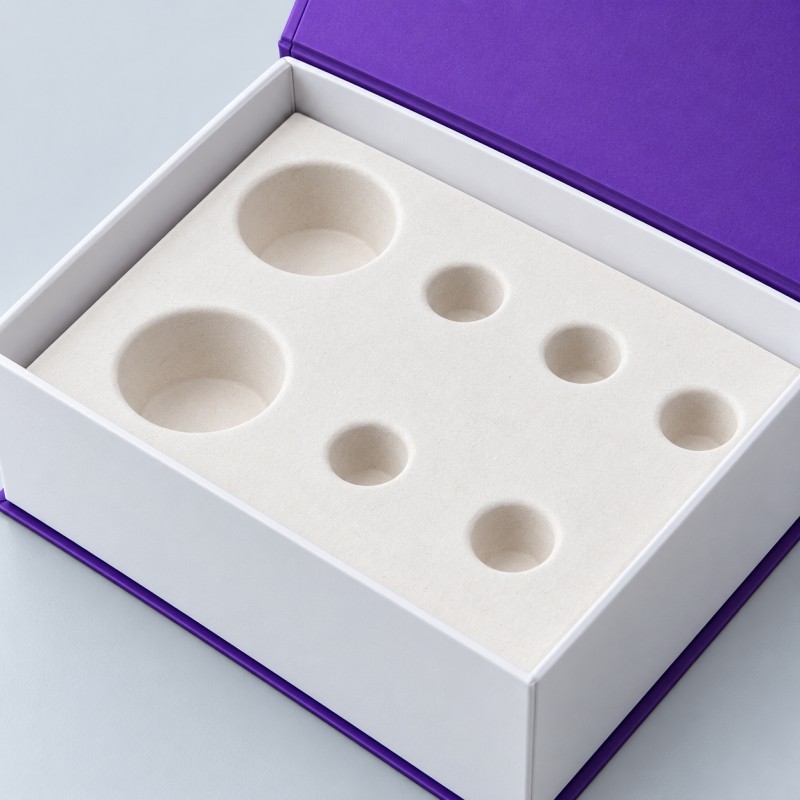 Custom molded pulp insert for fiber based product packaging