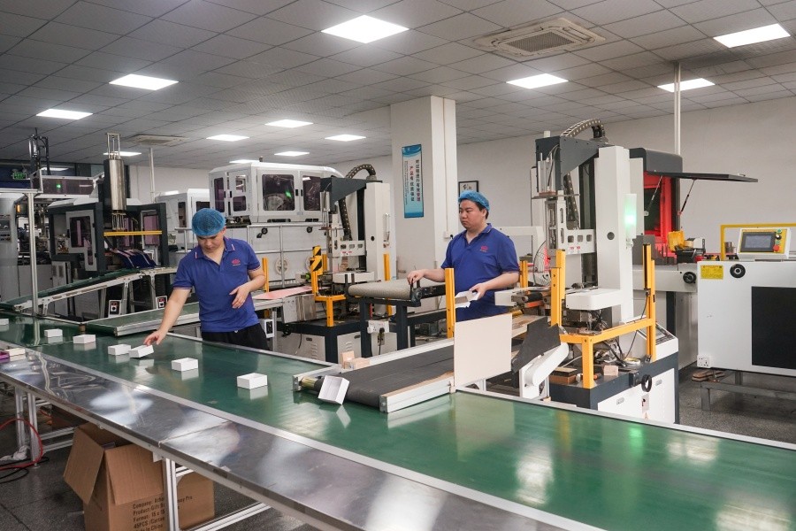 Automatic rigid box making machine and paper wrapping production at DHP Boxes factory in China