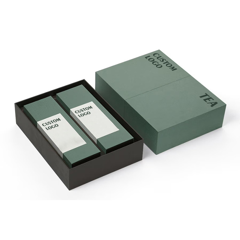 Green custom rigid tea packaging box displaying two individually branded tea cartons