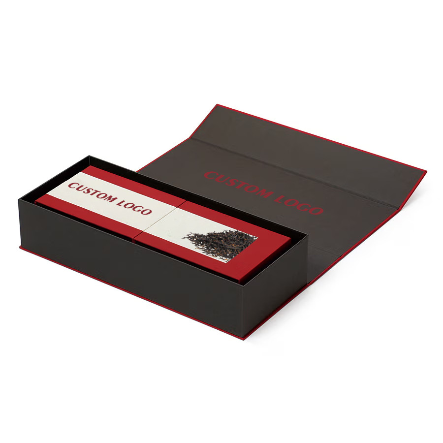 Open black and red book-style luxury tea gift box with fitted rectangular inner tea cartons